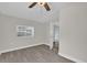 Bright bedroom with window and wood-look floors at 923 Ferndell Rd, Orlando, FL 32808