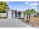 Modern home exterior with grey and white paint, and a landscaped front yard at 923 Ferndell Rd, Orlando, FL 32808