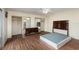 Main bedroom with wood-look floors and mirrored closet doors at 95 Moonstone Ct, Port Orange, FL 32129