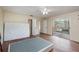 Bedroom with wood-look floors, ceiling fan, and private balcony at 95 Moonstone Ct, Port Orange, FL 32129