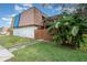 Two-story condo building with brown roof and wooden fence at 95 Moonstone Ct, Port Orange, FL 32129