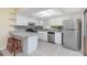 Modern kitchen with white cabinets and stainless steel appliances at 95 Moonstone Ct, Port Orange, FL 32129