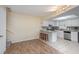 White kitchen with granite countertops and tile floors at 95 Moonstone Ct, Port Orange, FL 32129