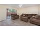 Living room with sectional sofa and access to patio at 95 Moonstone Ct, Port Orange, FL 32129