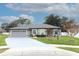 Single-story home with gray exterior, attached garage, and landscaped yard at 962 Canary Lake Ct, Sanford, FL 32773