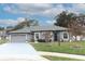 Single-story home with gray exterior, attached garage, and landscaped yard at 962 Canary Lake Ct, Sanford, FL 32773