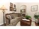 Living room with a tufted sofa and wooden coffee table at 962 Canary Lake Ct, Sanford, FL 32773