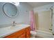 Bathroom with tub and wood vanity at 10738 Se 50Th Ave, Belleview, FL 34420