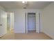 Bedroom with closet, carpet flooring, and access to another room at 10738 Se 50Th Ave, Belleview, FL 34420