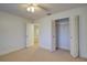 Bedroom with closet, carpet flooring, and access to another room at 10738 Se 50Th Ave, Belleview, FL 34420