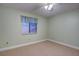 Bedroom with ceiling fan and window at 10738 Se 50Th Ave, Belleview, FL 34420