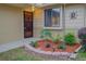 Condo entryway with a security door, window, and landscaped planter at 10738 Se 50Th Ave, Belleview, FL 34420