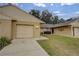 Brick condo with a single car garage and small front yard at 10738 Se 50Th Ave, Belleview, FL 34420