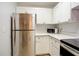 Modern kitchen with stainless steel appliances and white cabinets at 10738 Se 50Th Ave, Belleview, FL 34420