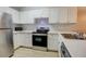 Modern kitchen with white cabinets and stainless steel appliances at 10738 Se 50Th Ave, Belleview, FL 34420
