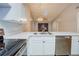 Updated kitchen featuring white cabinets, stainless steel dishwasher, and breakfast bar at 10738 Se 50Th Ave, Belleview, FL 34420