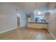 Open living area with wood floors and kitchen island view at 10738 Se 50Th Ave, Belleview, FL 34420