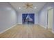 Living room with vaulted ceiling, wood floors, and access to balcony at 10738 Se 50Th Ave, Belleview, FL 34420