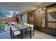 Covered patio with outdoor dining furniture and view of fenced yard at 10738 Se 50Th Ave, Belleview, FL 34420