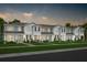 Modern townhome community with attached garages and landscaped yards at 11175 Rising Sun St, Orlando, FL 32829