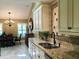 Kitchen features granite countertops, custom cabinetry, and a tile backsplash at 121 Wimbledon Cir, Lake Mary, FL 32746