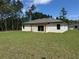 Spacious backyard with a covered patio, ideal for outdoor entertaining at 13188 Sw Sw 65Th Cir, Ocala, FL 34473