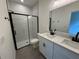 Modern bathroom featuring double sinks, black fixtures, and a sleek glass-enclosed shower for a luxurious feel at 13188 Sw Sw 65Th Cir, Ocala, FL 34473