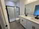 Bathroom features double vanity, large mirror, and walk-in shower at 13188 Sw Sw 65Th Cir, Ocala, FL 34473