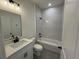 Modern bathroom with white vanity, bathtub, and marble-look shower at 13188 Sw Sw 65Th Cir, Ocala, FL 34473