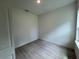 Bright bedroom featuring wood-look flooring and ample natural light, ready for personalization at 13188 Sw Sw 65Th Cir, Ocala, FL 34473