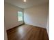 Well-lit bedroom, showcasing wood-look floors and a window at 13188 Sw Sw 65Th Cir, Ocala, FL 34473