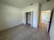 Bright bedroom featuring a closet and light wood-look flooring for a modern, clean aesthetic at 13188 Sw Sw 65Th Cir, Ocala, FL 34473