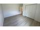 Neat bedroom with a large closet, light walls, and attractive wood-look flooring at 13188 Sw Sw 65Th Cir, Ocala, FL 34473