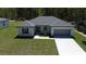 Charming single-story home with a two-car garage and pristine landscaping at 13188 Sw Sw 65Th Cir, Ocala, FL 34473