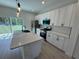 Contemporary kitchen featuring an island, stainless appliances, and sleek cabinets at 13188 Sw Sw 65Th Cir, Ocala, FL 34473