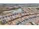 Aerial view of a residential community with houses, streets, and a lake at 13567 Abberwick Dr, Orlando, FL 32832