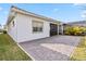 Landscaped backyard featuring a brick patio and a partially covered lanai at 13567 Abberwick Dr, Orlando, FL 32832