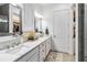 Spa-like bathroom featuring double sinks, a large mirror and a walk-in shower at 13567 Abberwick Dr, Orlando, FL 32832