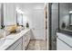 Elegant bathroom with double vanity, large mirror, and walk-in shower at 13567 Abberwick Dr, Orlando, FL 32832