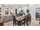 Open concept dining area with wooden table and view of living room and patio at 13567 Abberwick Dr, Orlando, FL 32832