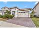 Two-story home with a two-car garage and manicured landscaping at 13567 Abberwick Dr, Orlando, FL 32832