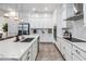 Modern kitchen with white cabinets, marble countertops, and stainless steel appliances at 13567 Abberwick Dr, Orlando, FL 32832