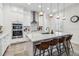 Modern kitchen with white cabinets, marble countertops, and stainless steel appliances at 13567 Abberwick Dr, Orlando, FL 32832