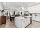 Open concept kitchen with island, stainless steel appliances, and views into the living area at 13567 Abberwick Dr, Orlando, FL 32832