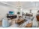 Bright living room with sectional sofa, coffee table and access to the kitchen at 13567 Abberwick Dr, Orlando, FL 32832