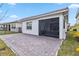 Spacious paver patio with screened enclosure and lush landscaping at 13567 Abberwick Dr, Orlando, FL 32832