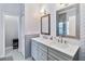 Stylish bathroom featuring a double vanity with granite countertops and modern herringbone tile backsplash at 14457 Jamaica Dogwood Dr, Orlando, FL 32828