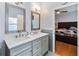 Elegant bathroom with double sinks, gray tile, and modern fixtures at 14457 Jamaica Dogwood Dr, Orlando, FL 32828