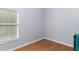 Empty bedroom has hardwood floors, neutral walls, and natural light at 14457 Jamaica Dogwood Dr, Orlando, FL 32828