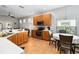 Well-lit kitchen featuring stainless steel appliances, wood cabinets, and an eat-in dining area at 14457 Jamaica Dogwood Dr, Orlando, FL 32828